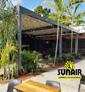 A wooden awning over restaurant garden and furniture